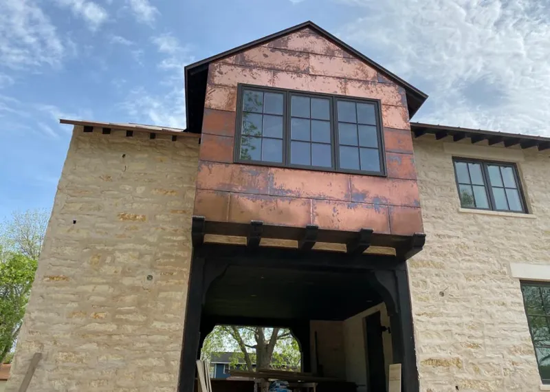 Copper metal panel facade on a stone building for Metal Roof Coating in Creswell